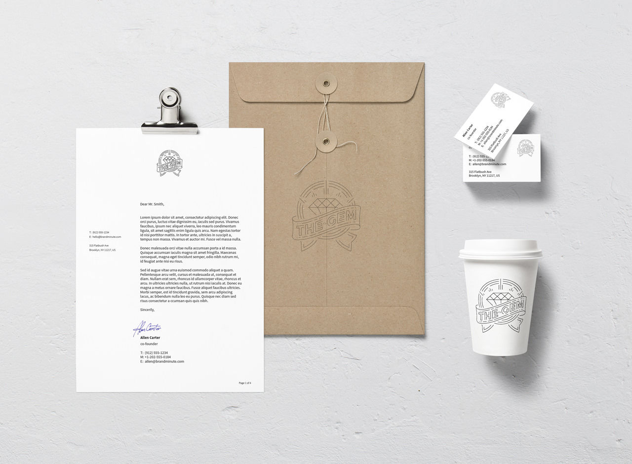 A mockup of branded stationery on a white surface, including a letter on a clipboard, a brown envelope, business cards, and a white coffee cup, all featuring the same black outlined logo.