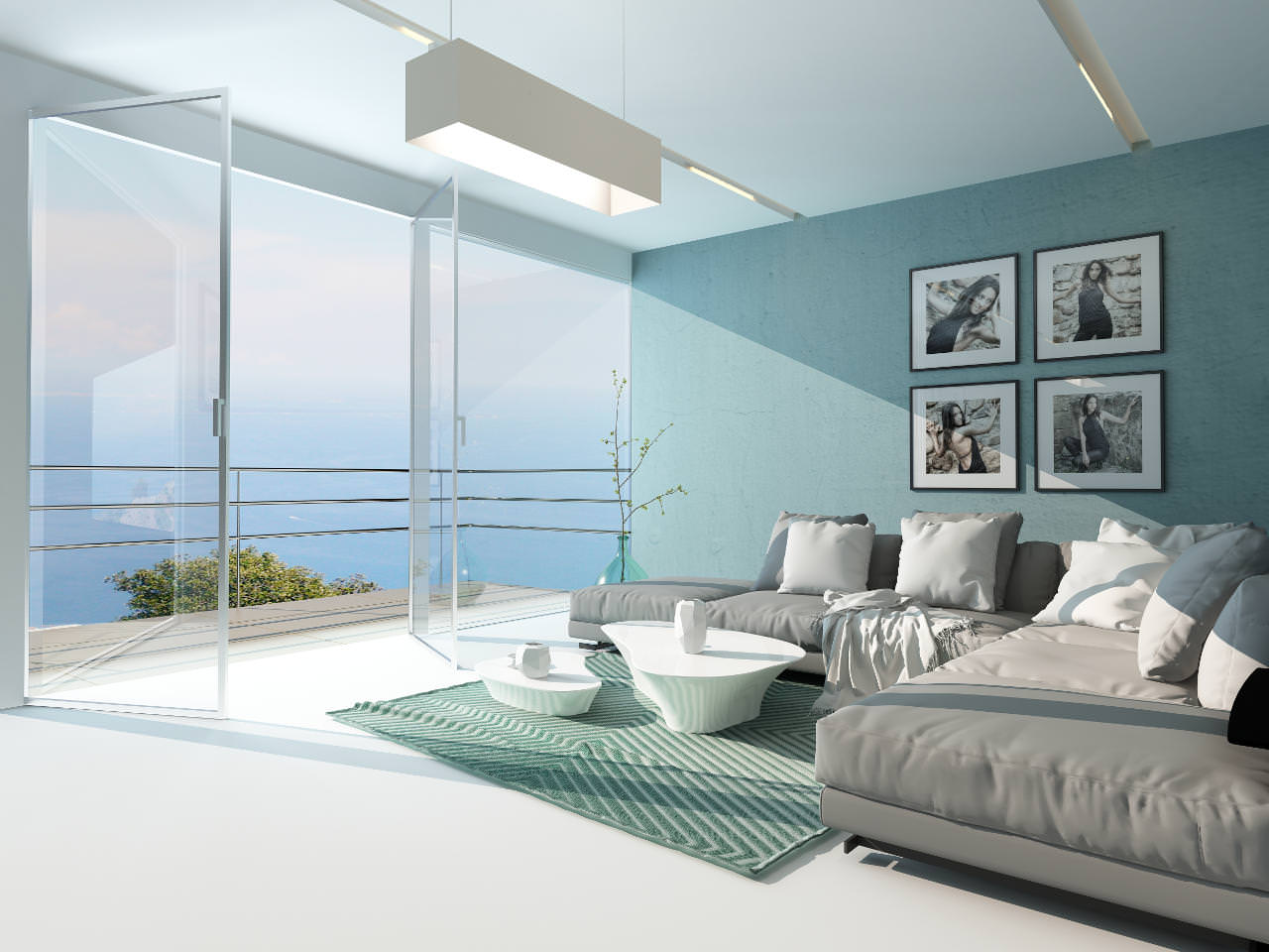 A modern living room with gray sofas, a green striped rug, white coffee tables, and wall art. Large glass doors open to a balcony with an ocean view under a bright, airy atmosphere.