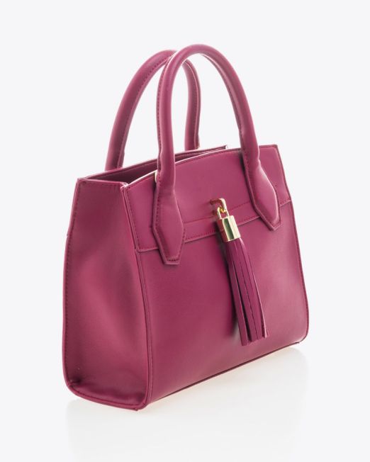 A stylish pink leather handbag with two handles and a decorative tassel, displayed on a white background.