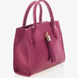 A stylish pink leather handbag with two handles and a decorative tassel, displayed on a white background.