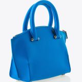A small, bright blue handbag with a structured shape, double handles, silver hardware, and a textured finish, displayed on a plain white background.