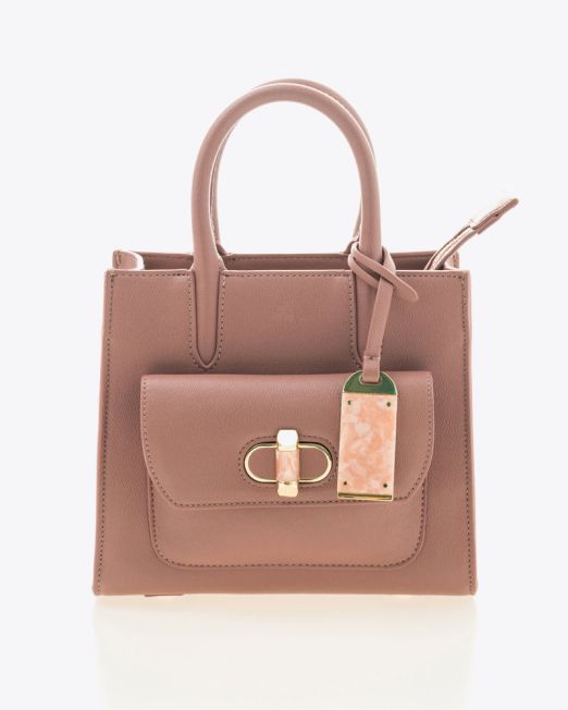 A small, blush pink leather handbag with top handles, a front pocket with a gold clasp, and a decorative pink marble luggage tag attached to one handle, set against a plain white background.
