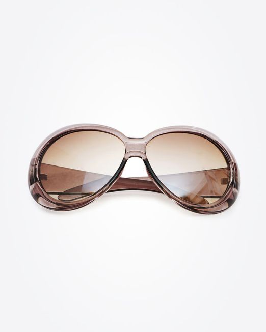 A pair of oversized, oval-shaped sunglasses with brown gradient lenses and translucent brown frames, displayed against a plain white background.