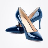A pair of shiny navy blue high-heeled pumps with pointed toes, arranged stylishly against a white background.