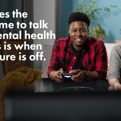 A man and woman smiling while playing a video game together, with text that reads: Sometimes the easiest time to talk about mental health and guns is when the pressure is off. The Lets Talk Guns Colorado logo is in the bottom right.