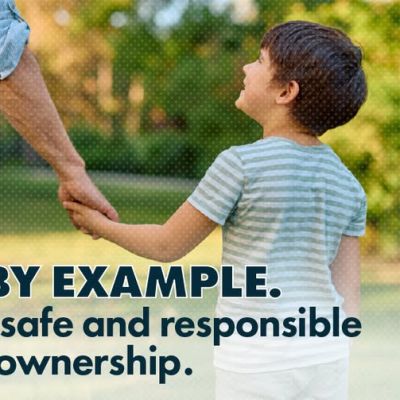 An adult and a young boy hold hands outdoors. Text reads, LEAD BY EXAMPLE. Practice safe and responsible firearm ownership. A blue speech bubble says, Lets Talk Guns Colorado.