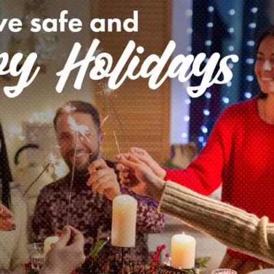 Four people holding sparklers at a holiday table with the text Have safe and Happy Holidays and a Lets Talk Guns Colorado logo.